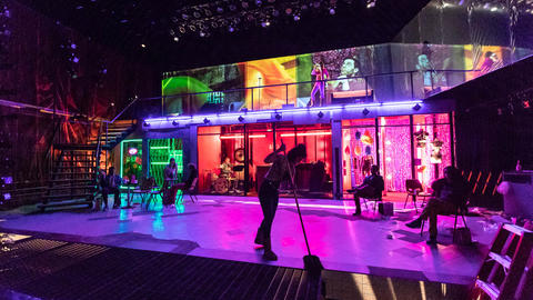 The stage for the TDM production of s.i.n.s.o.f.u.s. with a performer mopping downstage
