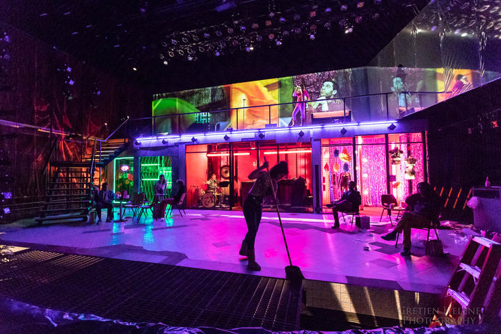The stage for the TDM production of s.i.n.s.o.f.u.s. with a performer mopping downstage